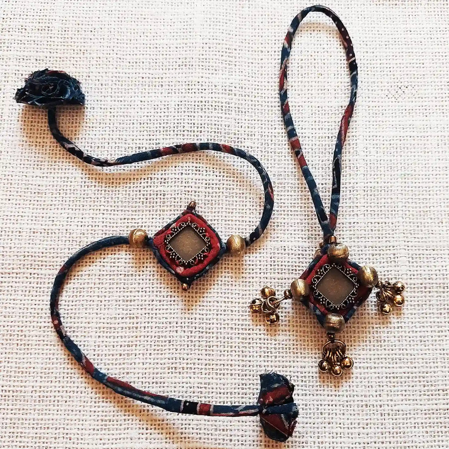 Handmade Dori Work Antique Ajrakh Bhaiya Bhabhi Rakhi With Roli Chawal Set Of 2 - Front View Laid Flat