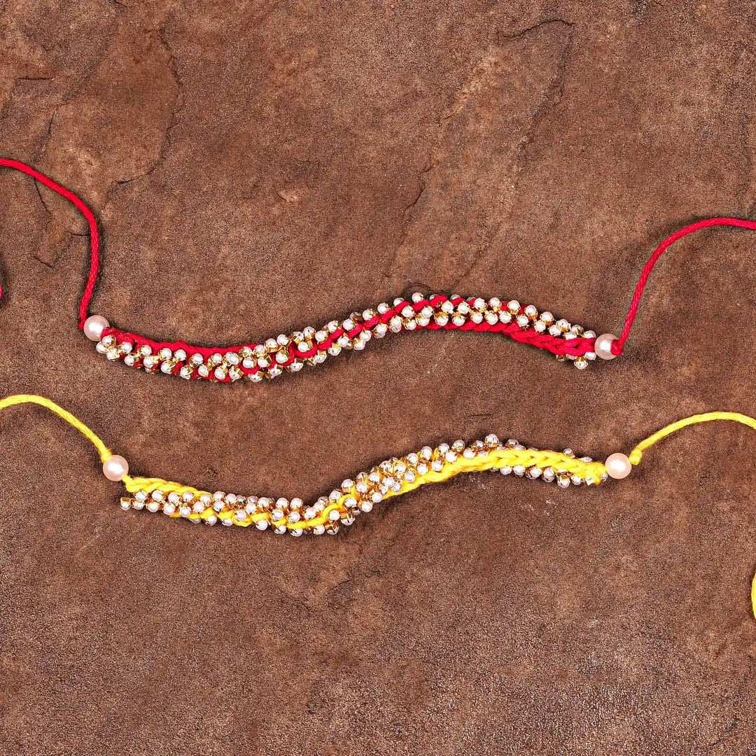 Handmade Crochet Pearl Rakhi With Roli Chawal Set Of 2 - Flat Lay with Two Bracelets