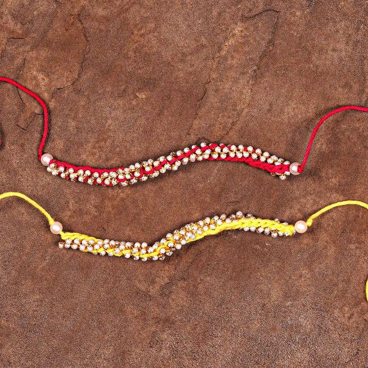Handmade Crochet Pearl Rakhi With Roli Chawal Set Of 2 - Flat Lay with Two Bracelets