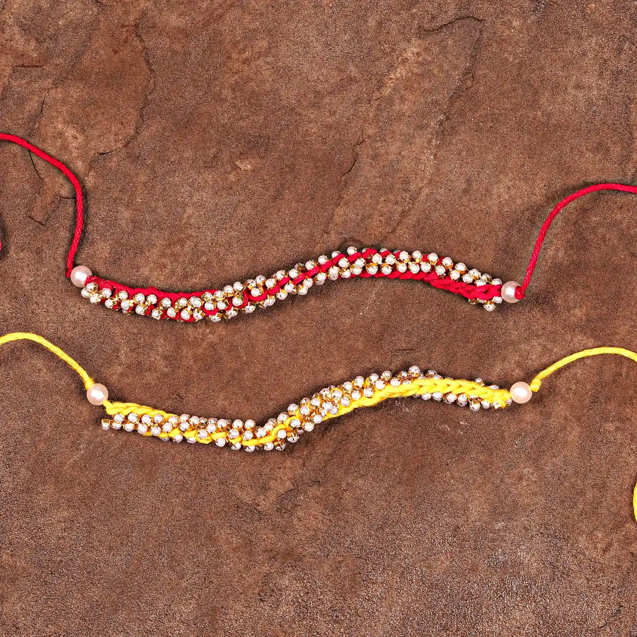 Handmade Crochet Pearl Rakhi With Roli Chawal Set Of 2 - Flat Lay with Two Bracelets
