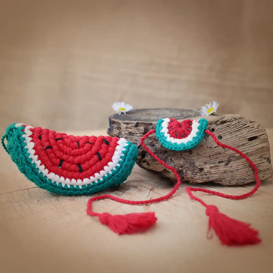 Handmade Crochet Watermelon Theme Kids Rakhi And Toy Combo With Roli Chawal Set Of 2 - Two Watermelon Crochet Pieces Displayed