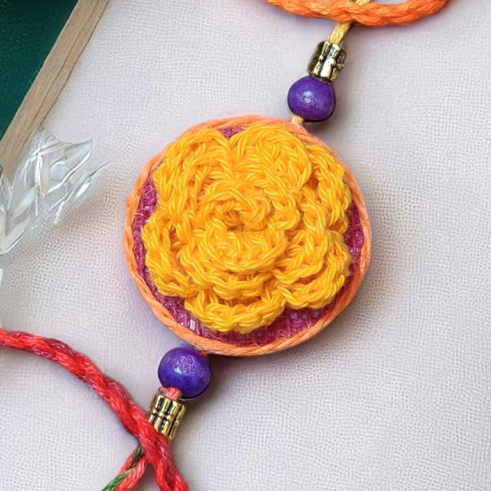 Customized Handmade Crochet Rose Theme Cotton Rakhi With Roli Chawal - Close-up of Yellow Flower Detail
