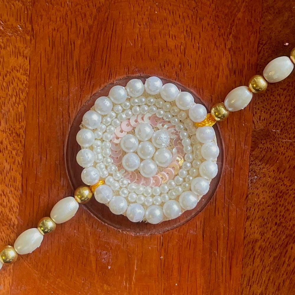 Handmade White Flower Design Pearl And Stone Bhaiya Bhabhi Rakhi - Close-up of Outer Circle Beads