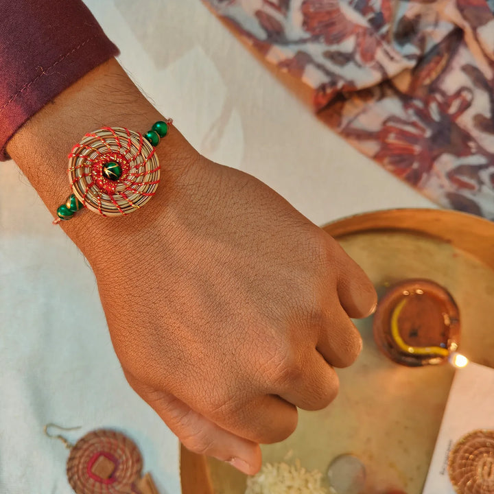 Eco Friendly Handmade Green Breads Pine Needle Rakhi With Pouch And Roli Chawal - On Wrist Showing Fit