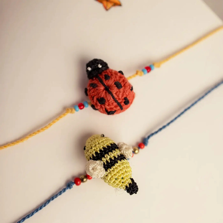 Handmade Crochet Beetle And Bee Theme Kids Rakhi With Roli Chawal Set Of 2 - Close-up of Crochet Bracelets