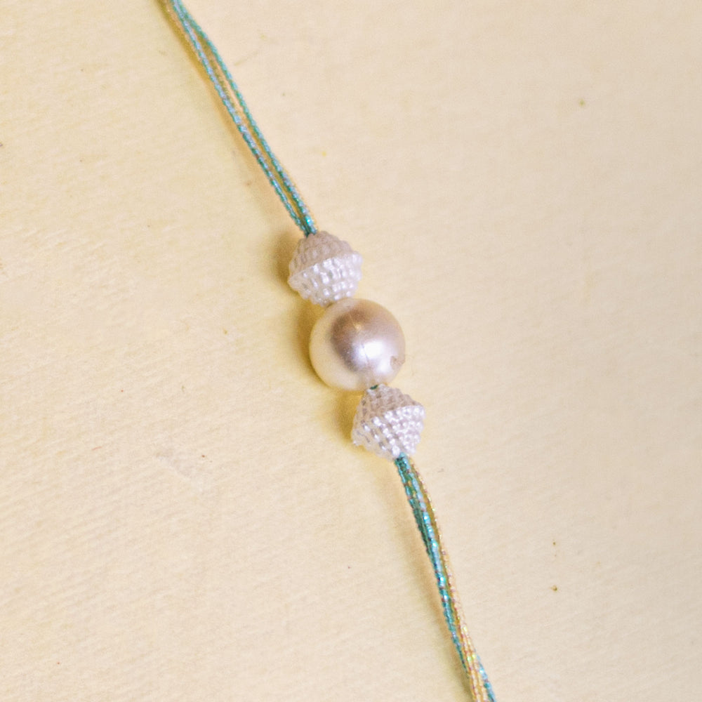 Handmade White Pearl And Ghungroo Rakhi With Roli Chawal - Single Rakhi Detail