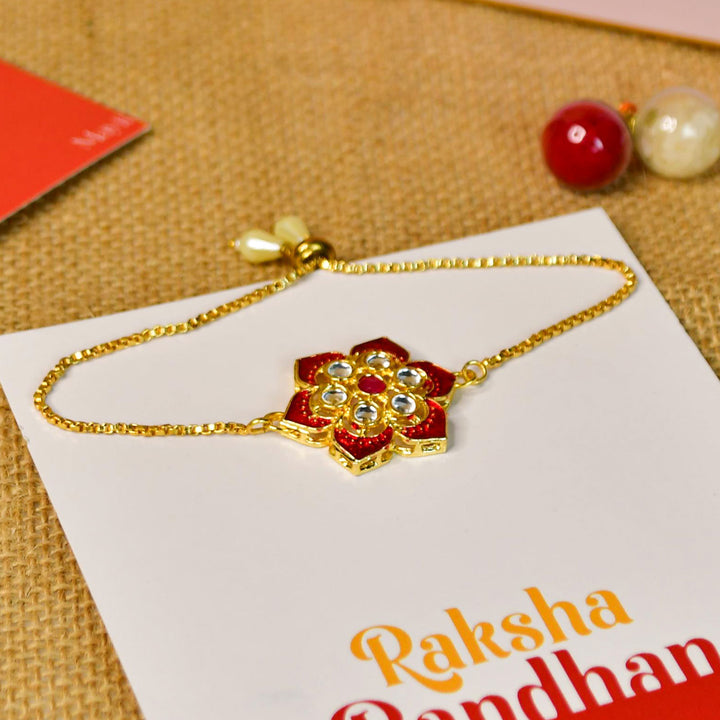 Red Floral Pearl And Stone Bracelet Rakhi Hamper With Chocolates And Roli Chawal For Brother Customizable Options Includes Up To 7 Goodies - Close-up of Rakhi Bracelet