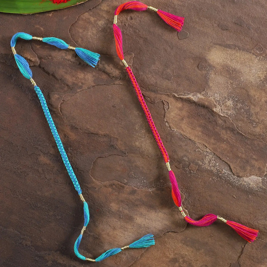 Handmade Minimal Pink And Blue Rakhi With Roli Chawal Set Of 2 - Laid Flat with Tassel Details