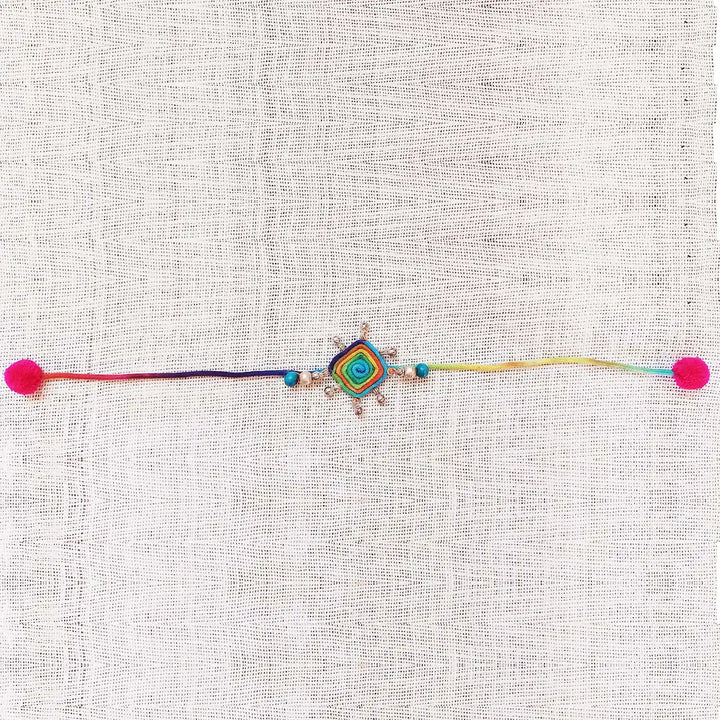 Handmade Dori Work Beaded Multicolor Rakhi With Roli Chawal - Full Length Laid Flat View
