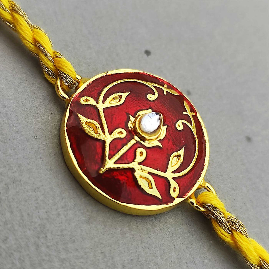 Handmade Meenakari Red Buta Brass Rakhi With Roli Chawal - Close-up of Rakhi design