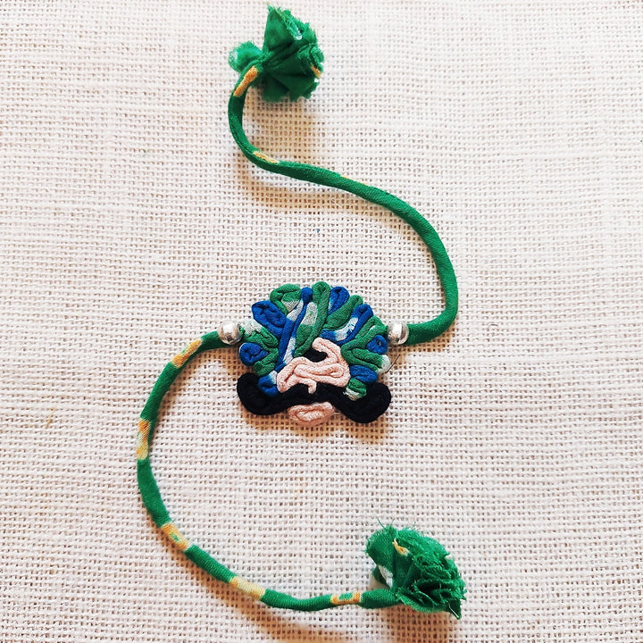 Handmade Dori Work Ethnic Rabari Rakhi With Roli Chawal - Flat Lay Green Thread Bracelet