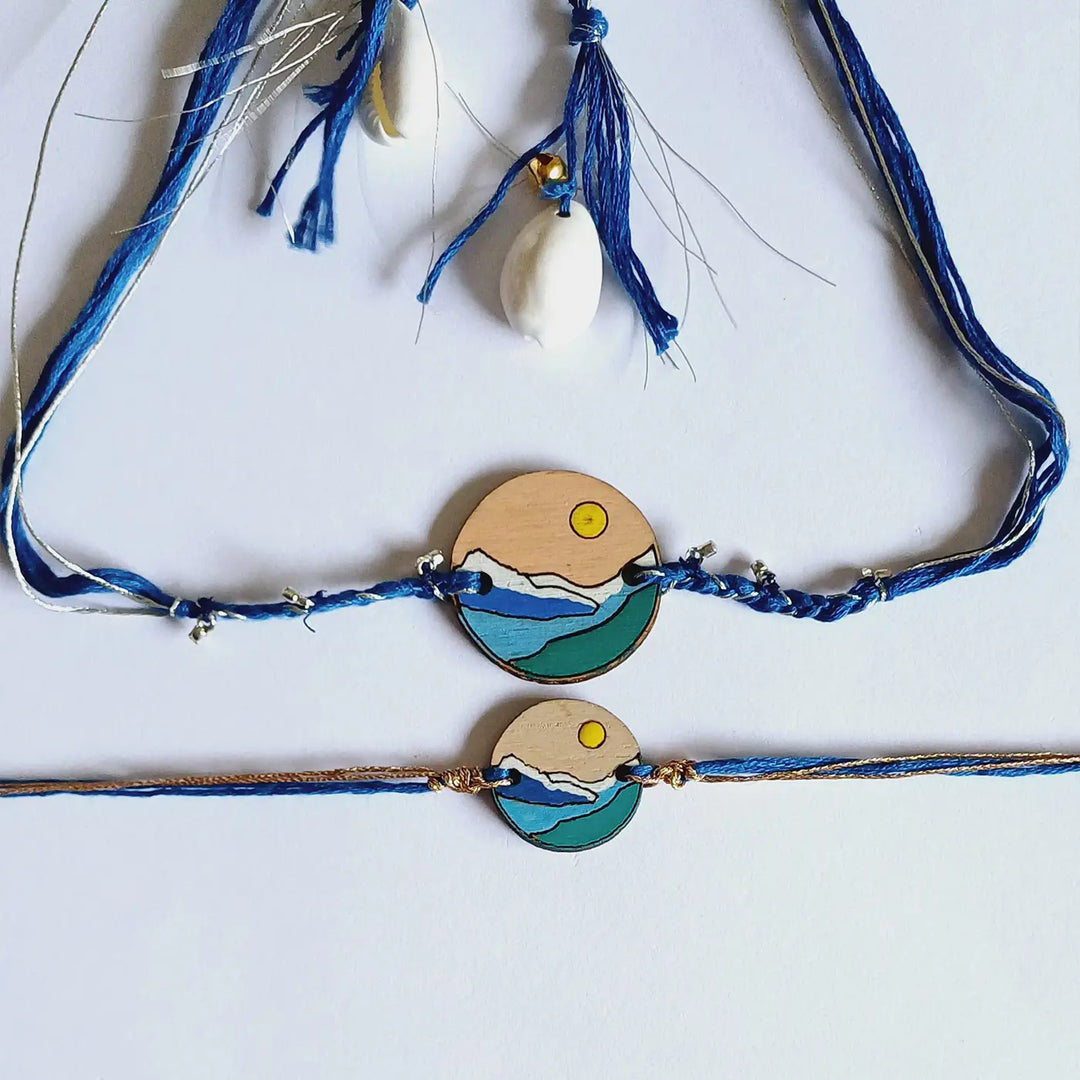 Handmade Blue Mountain Snow Design Ghungroo & Shell Wooden Bhaiya Bhabhi Rakhi With Roli Chawal