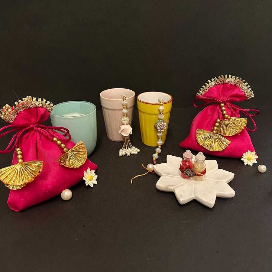 Handmade Riwaayat Duo Rakhi Hamper Includes 1 Marble Lotus 2 Kulhads 1 Candle 1 Kum Kum Chawal 1 Dry Fruit Potli And 1 Set Bhaiya Bhabhi Rakhi - Product Set Front View