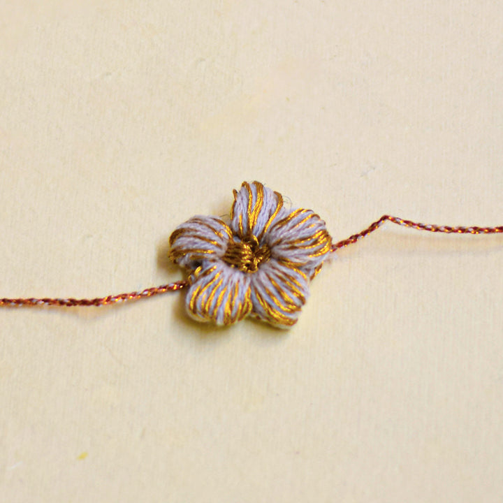 Handmade Crochet Flower And Ghungroo Design Bhaiya Bhabhi Rakhi With Roli Chawal - Single floral bracelet close-up front