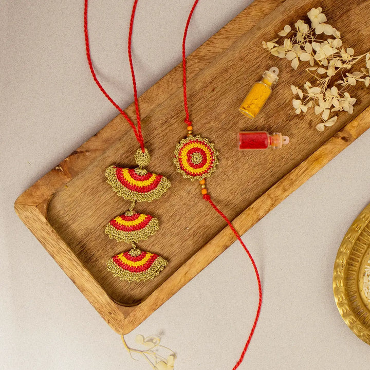 Handmade Crochet Tarang Bhaiya Bhabhi Rakhi With Roli Chawal Set Of 2 - Flat Lay with Decorative Accents and Tray