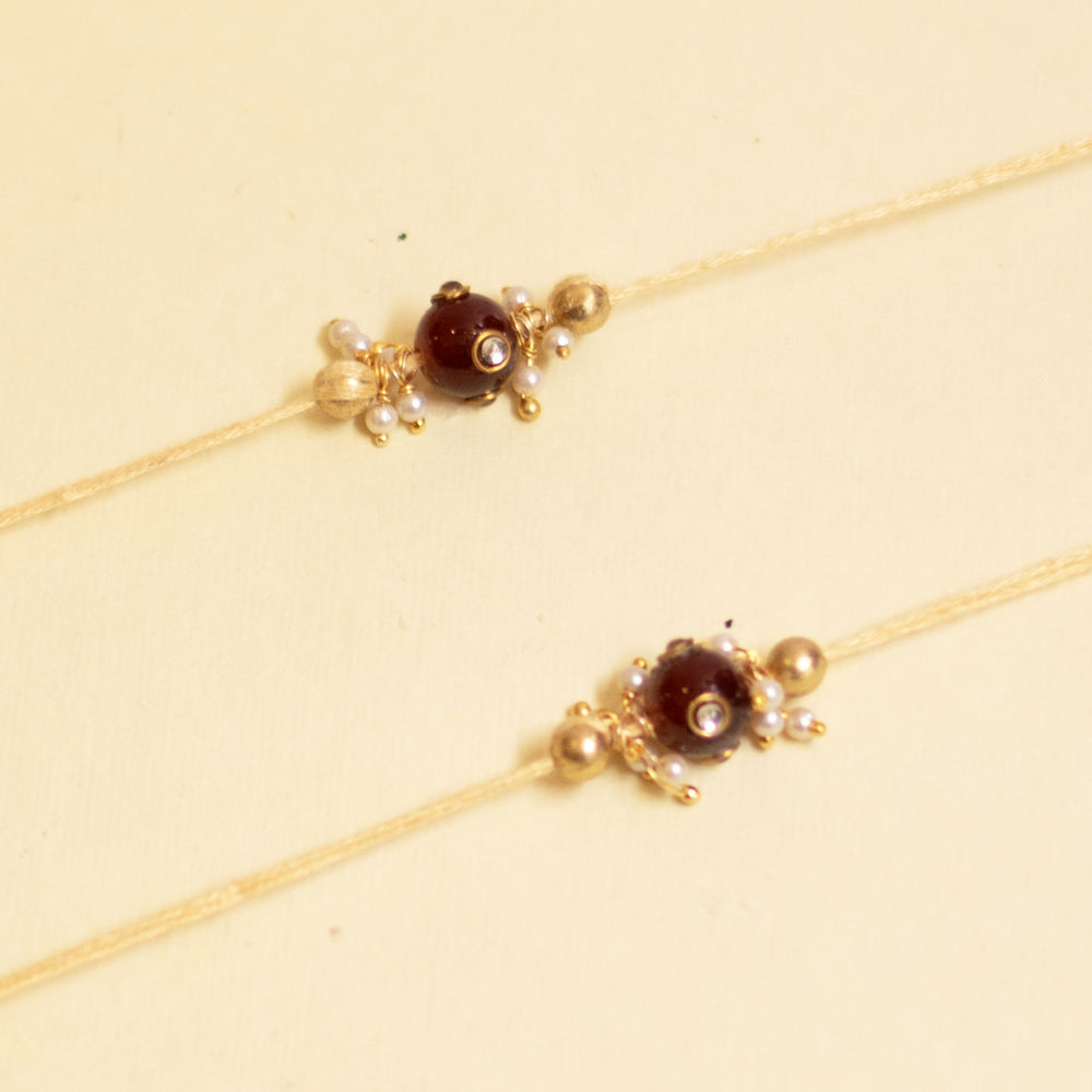 Handmade Red Manak Pearl Rakhi With Roli Chawal - Close-up of Necklace Details
