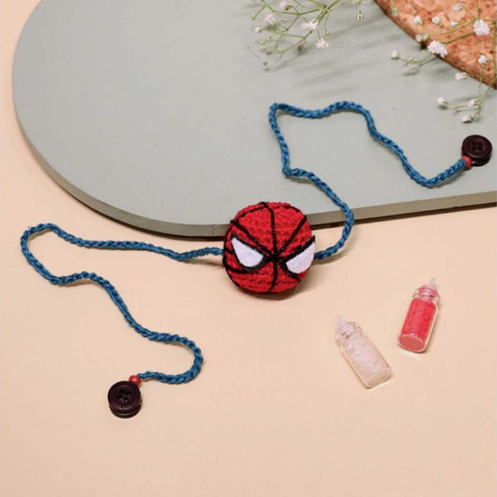 Handmade Crochet Spiderman Kids Rakhi With Roli Chawal - Flat Lay with Accessories