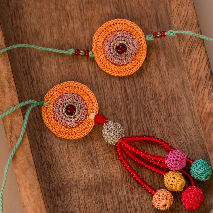 Handmade Crochet Kesaria Mandala Bhaiya Bhabhi Rakhi With Roli Chawal Set Of 2 - Close-up of Decorative Detail