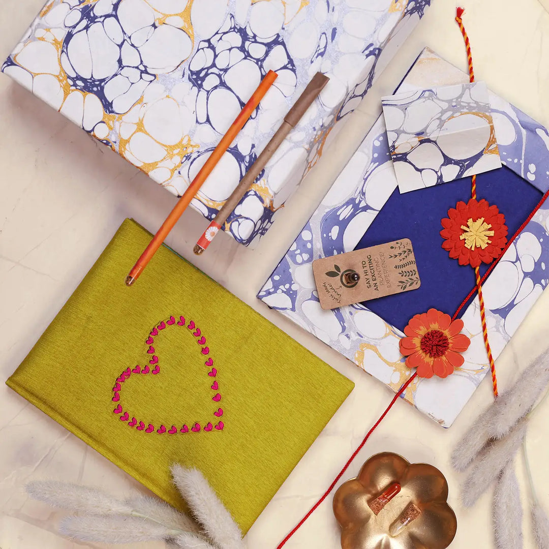 Eco-Friendly Festive Rakhi Hamper | Includes 1 Notebook, 1 Photo Frame, 1 Plantable Pen, 1 Plantable Pencil, 2 Rakhis, 1 Roli Chawal & 1 Greeting Card