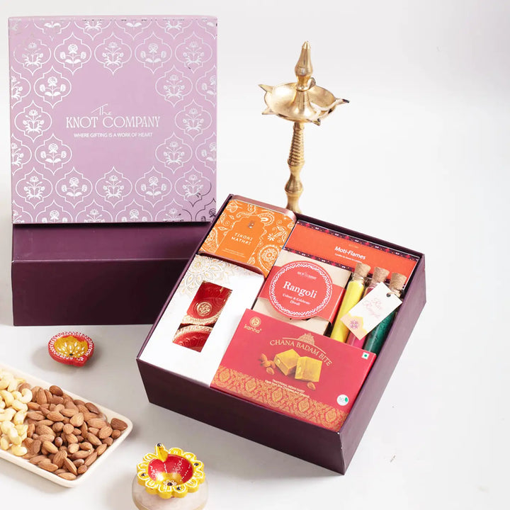 Festive Diwali Gift Hamper | Includes 2 Terracotta Diyas, 4 Rangoli Stencils, 3 Rangoli Color Tubes, 4 Ladoo Candles, 1 Chana Badam Bites, 1 Tikoni Mathri, 1 Gift Box