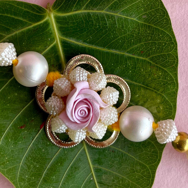 Handmade Purple Flower Design Pearl And Stone Bhaiya Bhabhi Rakhi - Close-up of Central Decoration