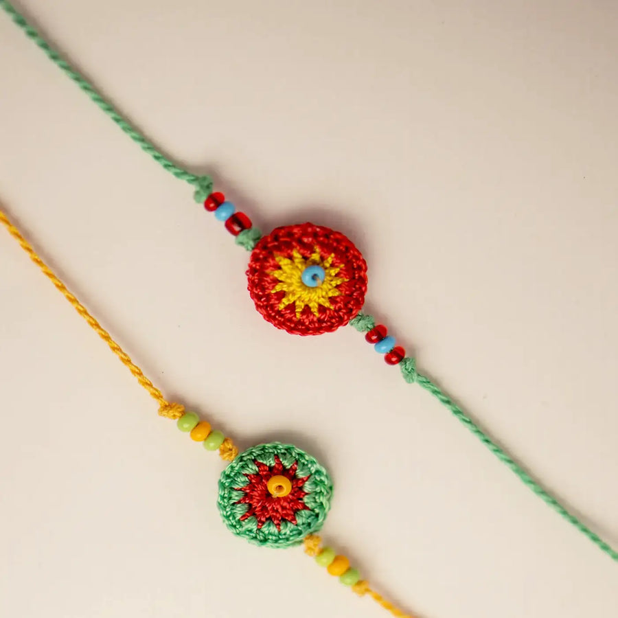 Handmade Crochet Green And Orange Ziba Rakhi With Roli Chawal Set Of 2 - Close-up of Two Bracelets