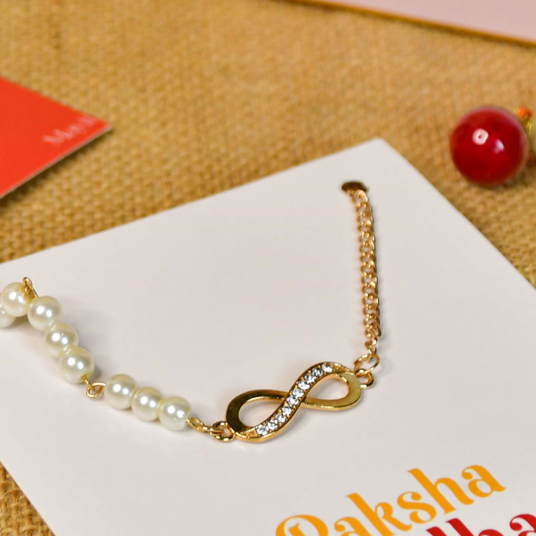 Beaded Infinity Pearl And Stone Bracelet Rakhi Hamper With Chocolates And Roli Chawal For Brother Customizable Options Includes Up To 7 Goodies - Close-up of Rakhi details