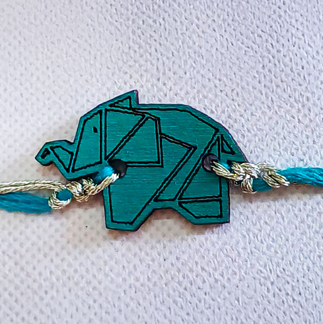 Handmade Blue Elephant Shape Wooden Rakhi With Roli Chawal For Brother - Macro Detail View