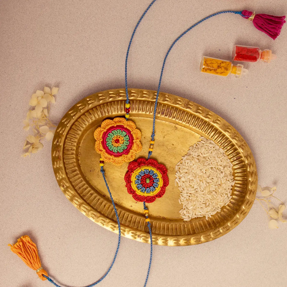Handmade Crochet Noor Rakhi With Roli Chawal Set Of 2 - Top View on Decorative Tray