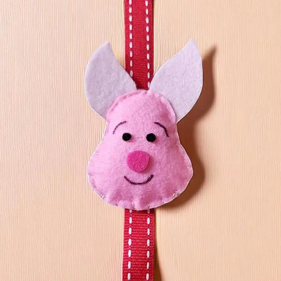 Handmade Piglet Theme Felt Kids Rakhi With Roli Chawal - Front Close-up View