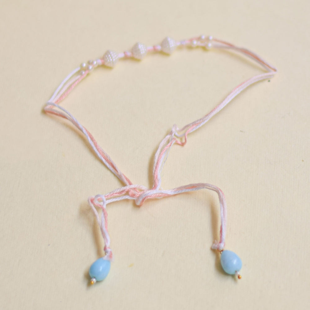 Handmade Trimurty Pearl Rakhi With Roli Chawal - Pink bracelet with bead ends