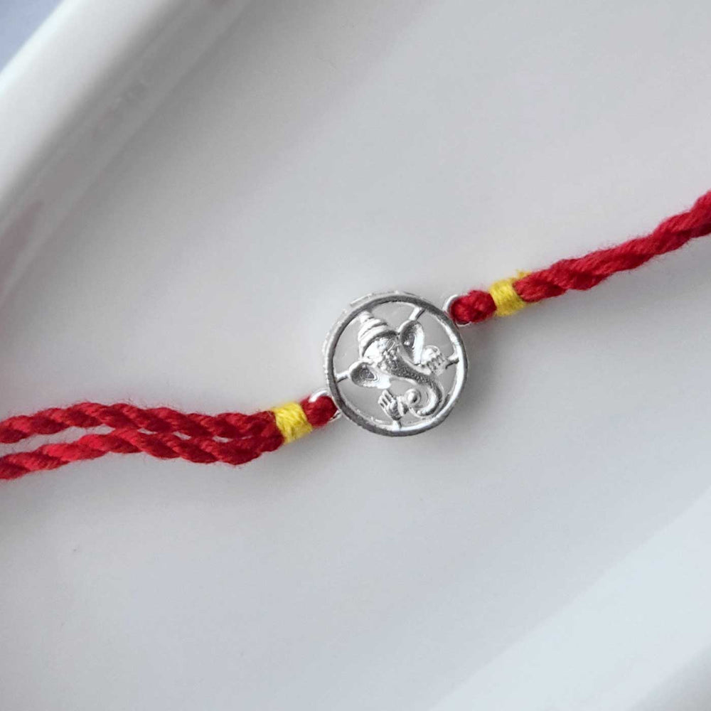 Handmade Ganesha Design Silver Rakhi Hamper With Roli Chawal For Brother - Flat Lay of Full Bracelet