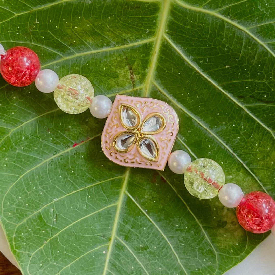 Handmade Pink Flower Design Pearl And Stone Rakhi - Close-up of Bracelet Detail