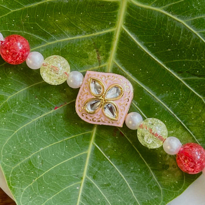 Handmade Pink Flower Design Pearl And Stone Rakhi - Close-up of Bracelet Detail