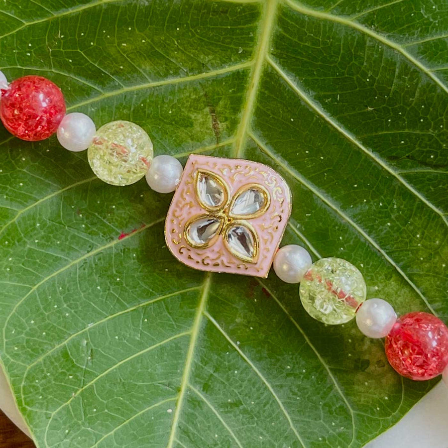 Handmade Pink Flower Design Pearl And Stone Rakhi - Close-up of Bracelet Detail