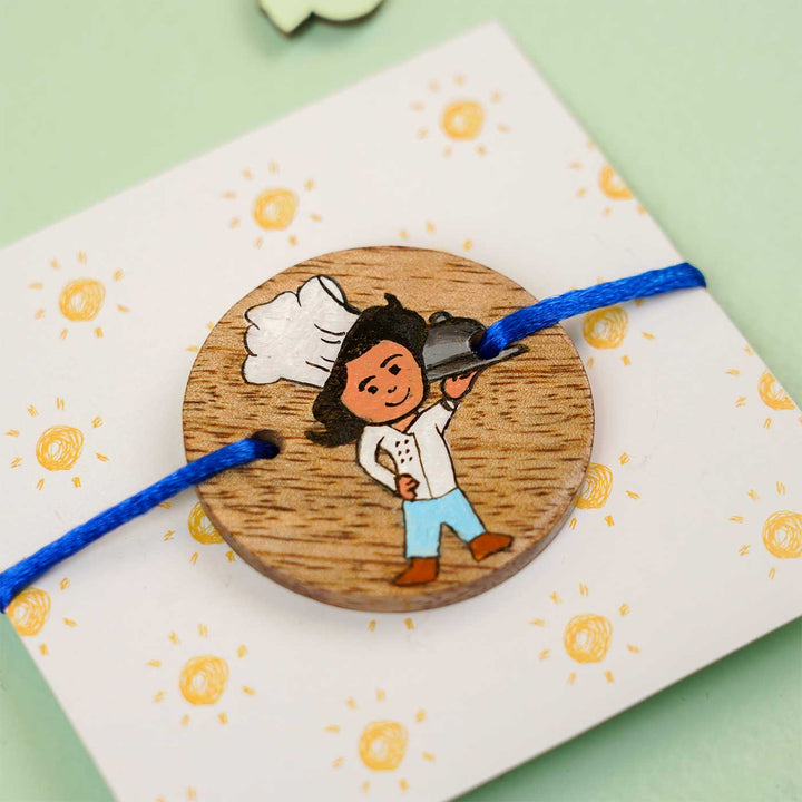 Personalized Hand Painted Chef Theme Wooden Rakhi With Roli Chawal - Close-up on Card Background