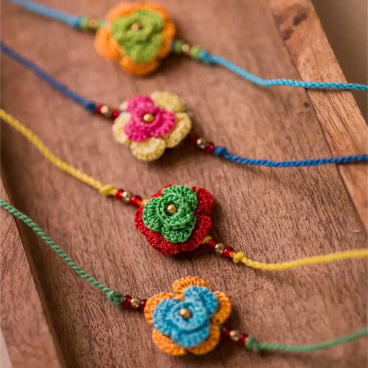 Handmade Crochet Multicolor Roses Rakhi With Roli Chawal Set Of 4 - Angled Close-up Display