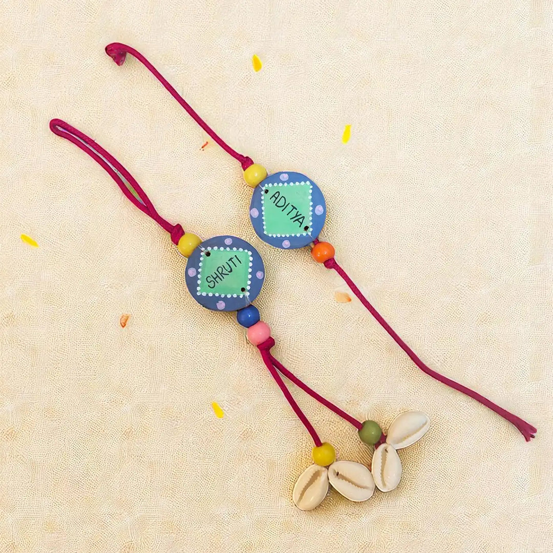 Personalized Round Blue & Green Shell Terracotta Bhaiya Bhabhi Rakhi | Set Of 2