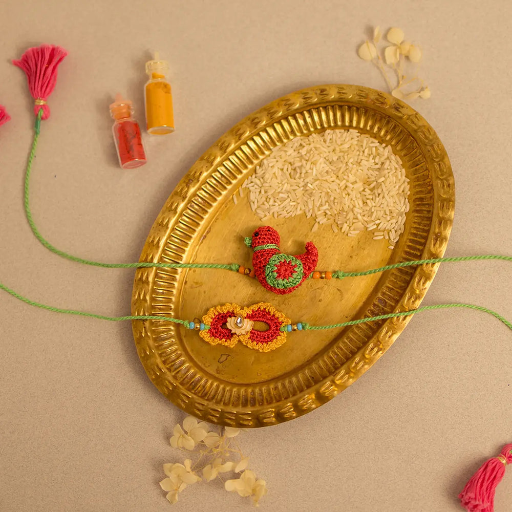 Handmade Crochet Paakhi And Phool Rakhi With Roli Chawal Set Of 2 - Top view with decorative elements