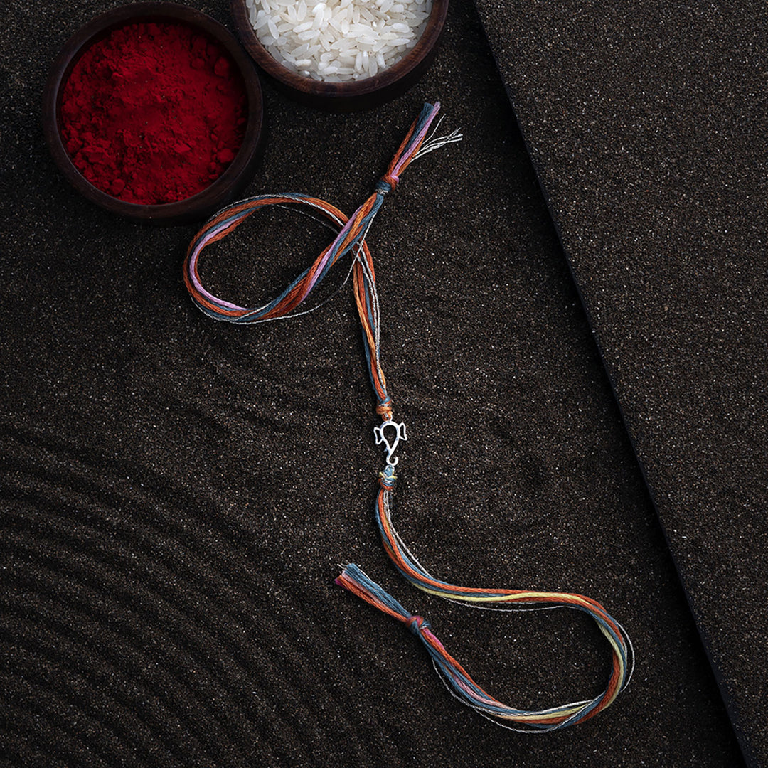 Handmade Ekdanta 925 Silver Rakhi With Roli Chawal For Brother - Full Length Laid Flat with Props