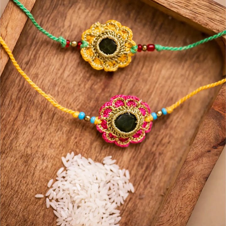Handmade Crochet Green And Red Kundan Rakhi With Roli Chawal Set Of 2 - Bracelets with decorative rice grains
