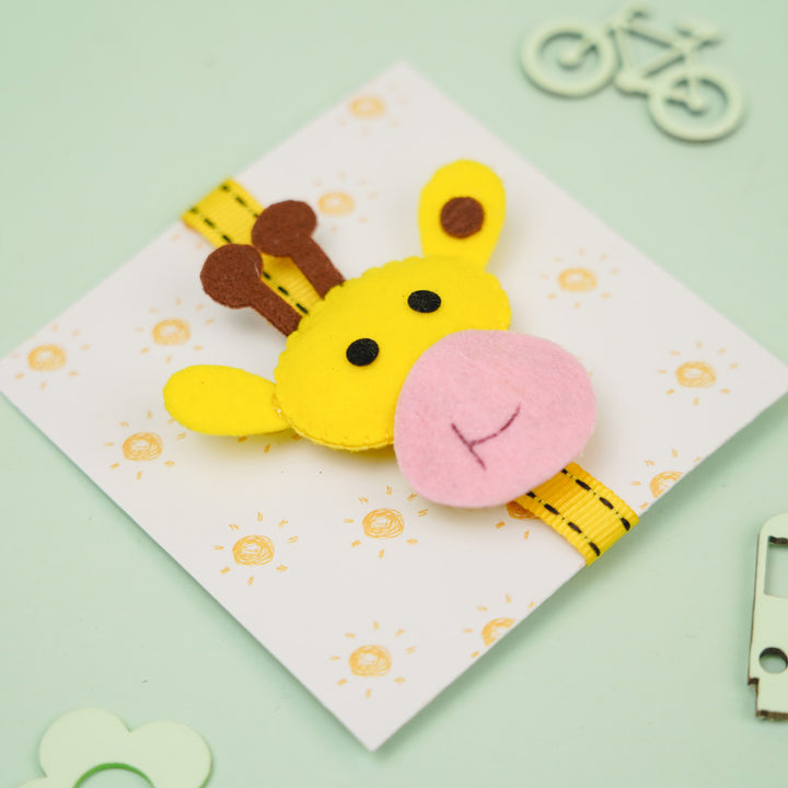 Handmade Giraffe Theme Felt Kids Rakhi With Roli Chawal - Angled View on Decorative Card