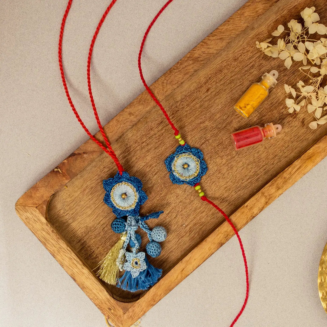 Handmade Crochet Neelkamal Bhaiya Bhabhi Rakhi With Roli Chawal Set Of 2 - Overhead Layout with Accessories