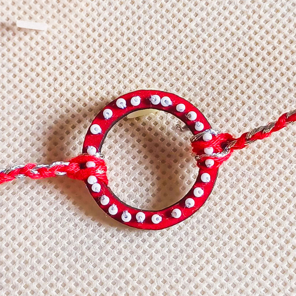 Handmade Round Beads Wooden Rakhi With Roli Chawal For Brother - Close-up of Red Bracelet Center