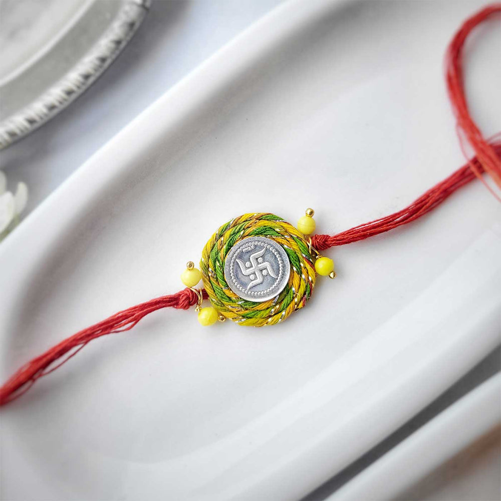 Handmade Swatik Design Silver Rakhi Hamper With Roli Chawal For Brother 1 - Rakhi detailed view on plate