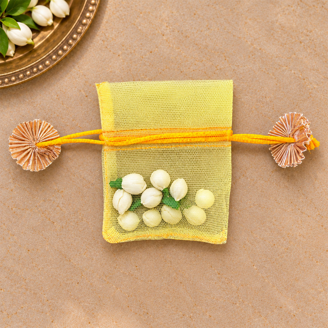 Hand-embellished Yellow Floral Net Potli With Shola Flowers For Festive Gifting