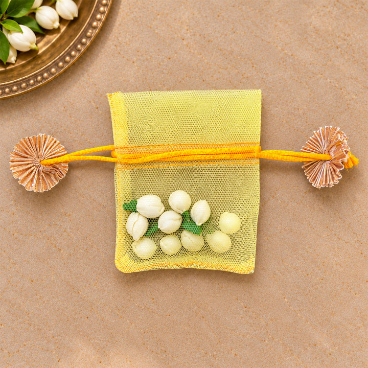 Hand-embellished Yellow Floral Net Potli With Shola Flowers For Festive Gifting