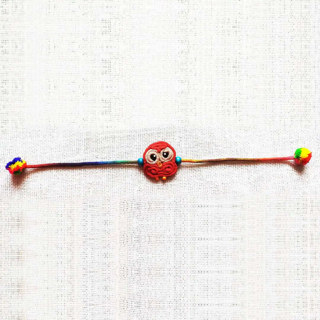 Handmade Dori Work Cute Owl Kids Rakhi With Roli Chawal - Flat Lay Full Product View