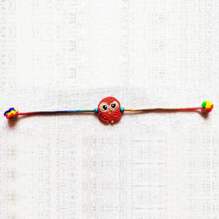 Handmade Dori Work Cute Owl Kids Rakhi With Roli Chawal - Flat Lay Full Product View