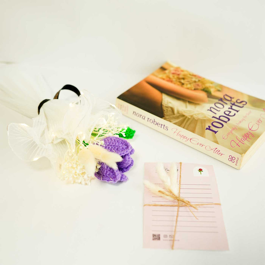 Personalized Handmade Crochet Purple Lily Rakhi Hamper Includes 1 Crochet Flower 1 Message Card And 1 Rakhi And Roli Chawal - Styled Product Arrangement with Book